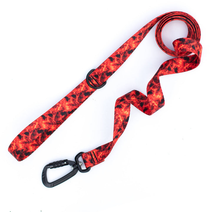 Red and black patterned dog leash with carabiner on a white background