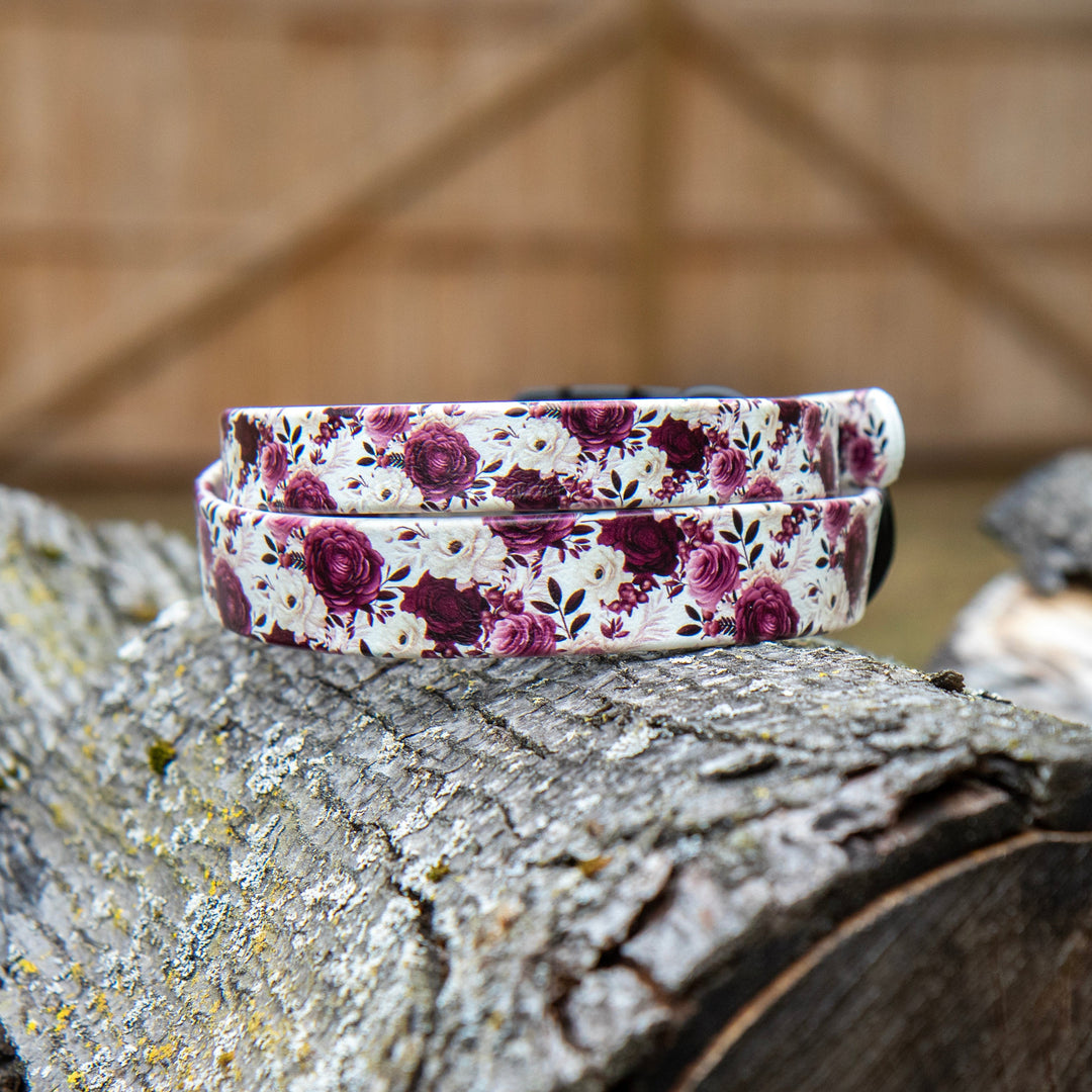 Floral-patterned dog collar on a wooden surface with a rustic background