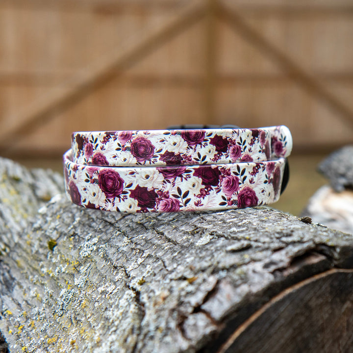 Floral-patterned dog collar on a wooden surface with a rustic background