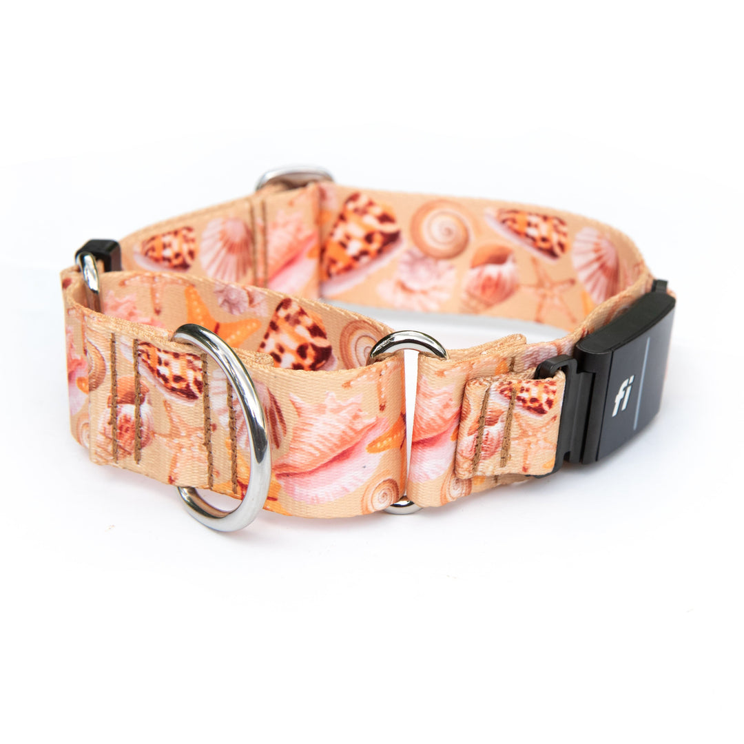 A dog collar featuring a seashell pattern in peach, pink, and beige tones, with silver metal hardware and a black plastic buckle.