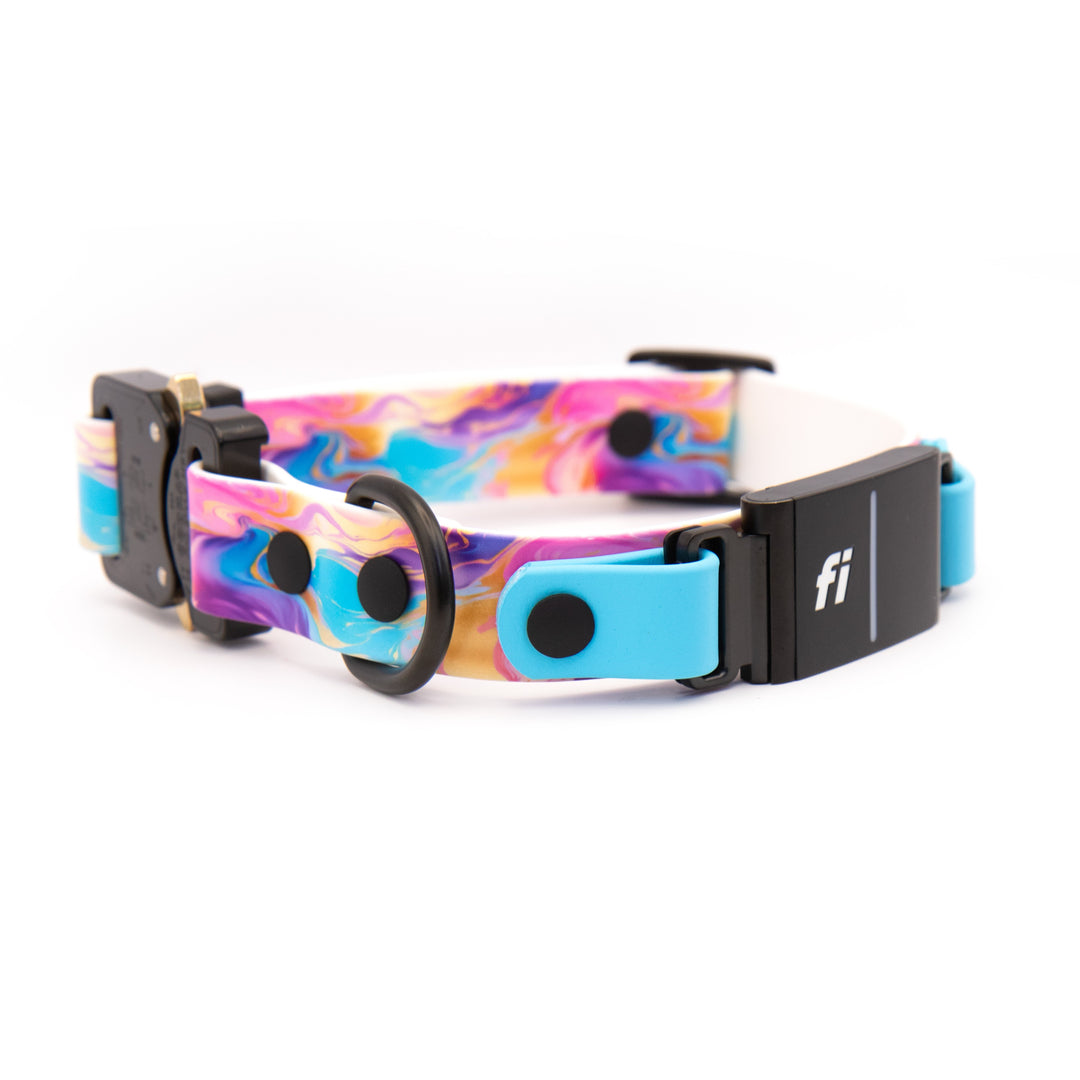 A dog collar with a colorful marbled pattern in pink, blue, yellow, and purple, featuring a black quick-release buckle and a black electronic tracker tag with a white &