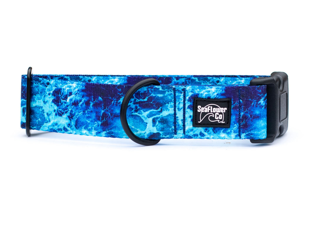 Blue marbled patterned dog collar with a visible brand logo on a white background