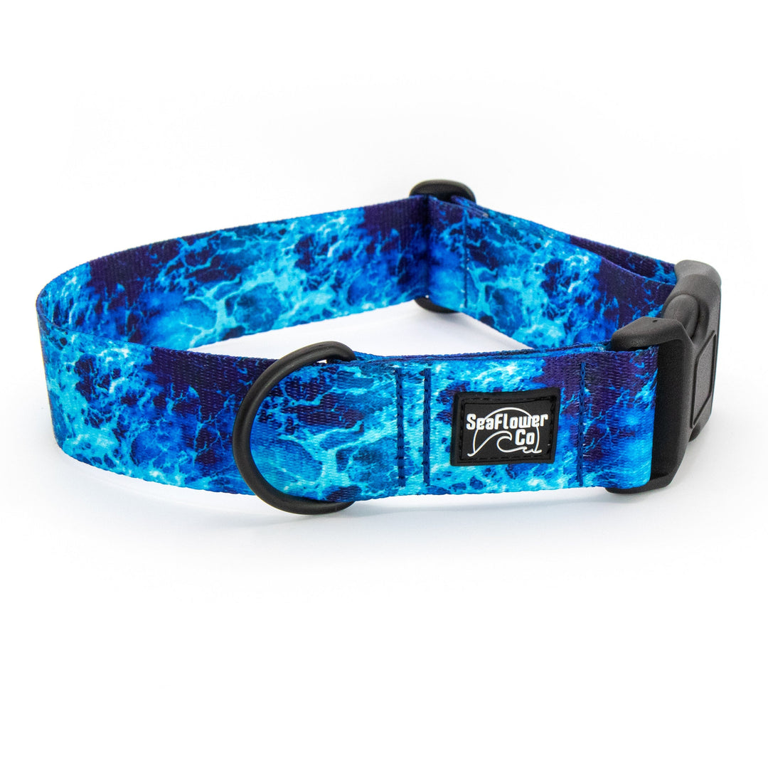 Blue marbled patterned dog collar with a visible brand logo on a white background