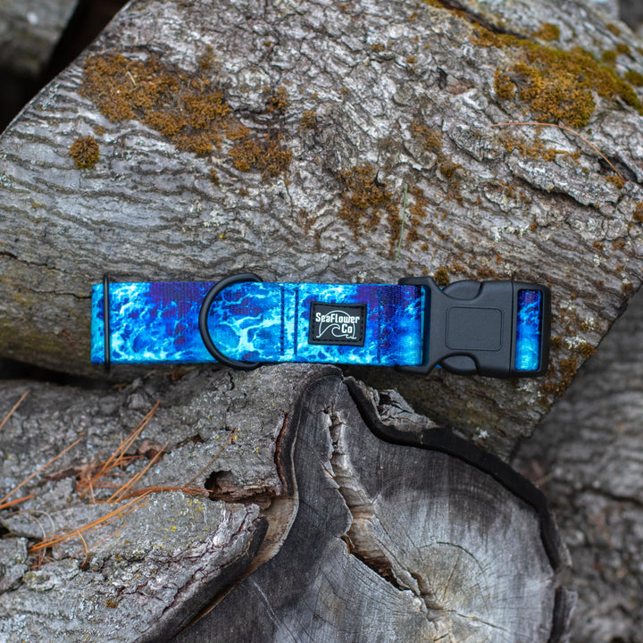 Dog collar with blue and black pattern on a wooden log